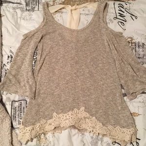 Cold shoulder sweater with lace and bow detail.